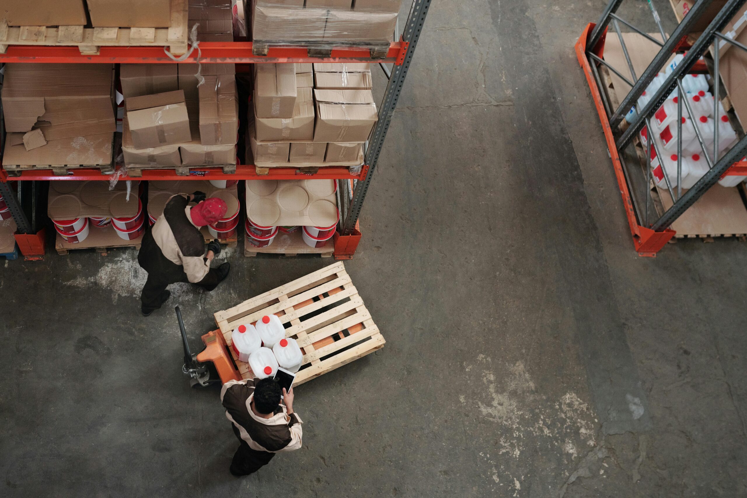 Employees at a big box store mishandle espresso machines and products on a pallet