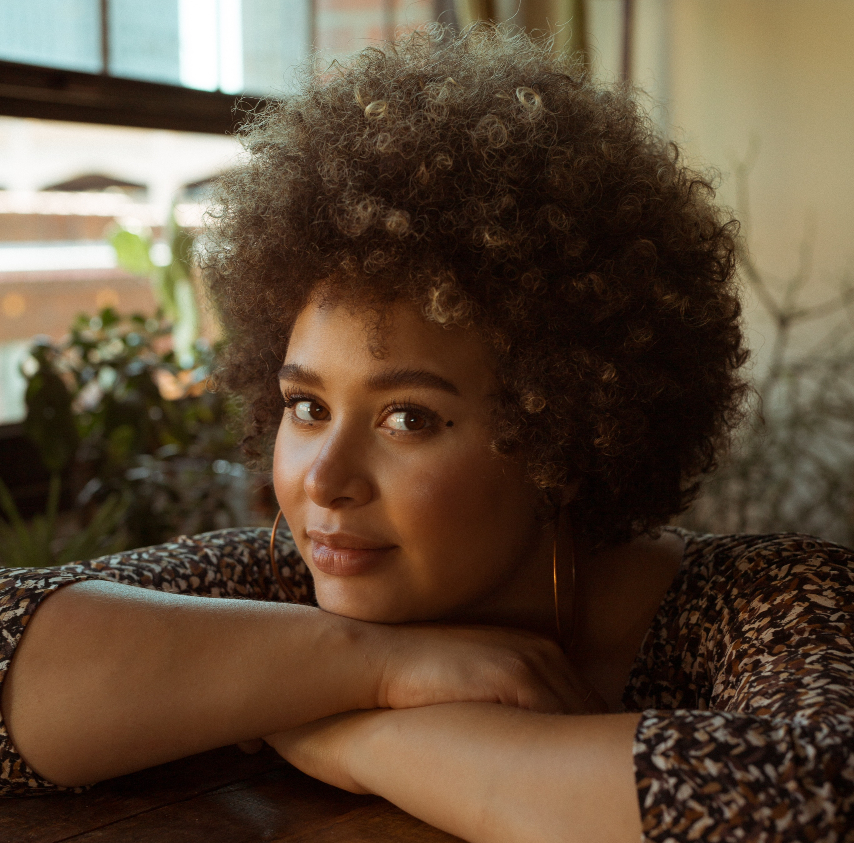 Kiki of Impossible Coffee helps schedule coffee shop service calls and cafe tune-ups sitting in a room of sunshine.